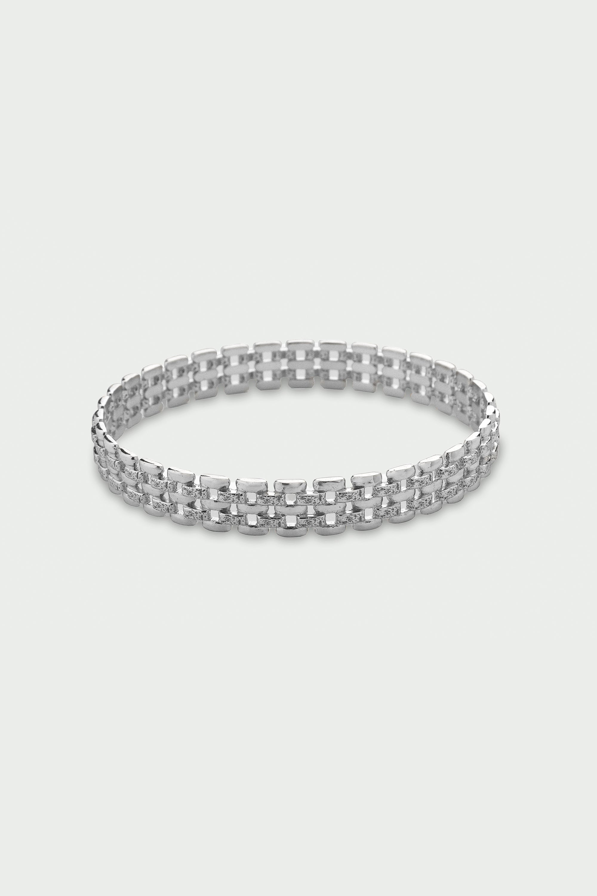 Silver bracelet on a light gray background