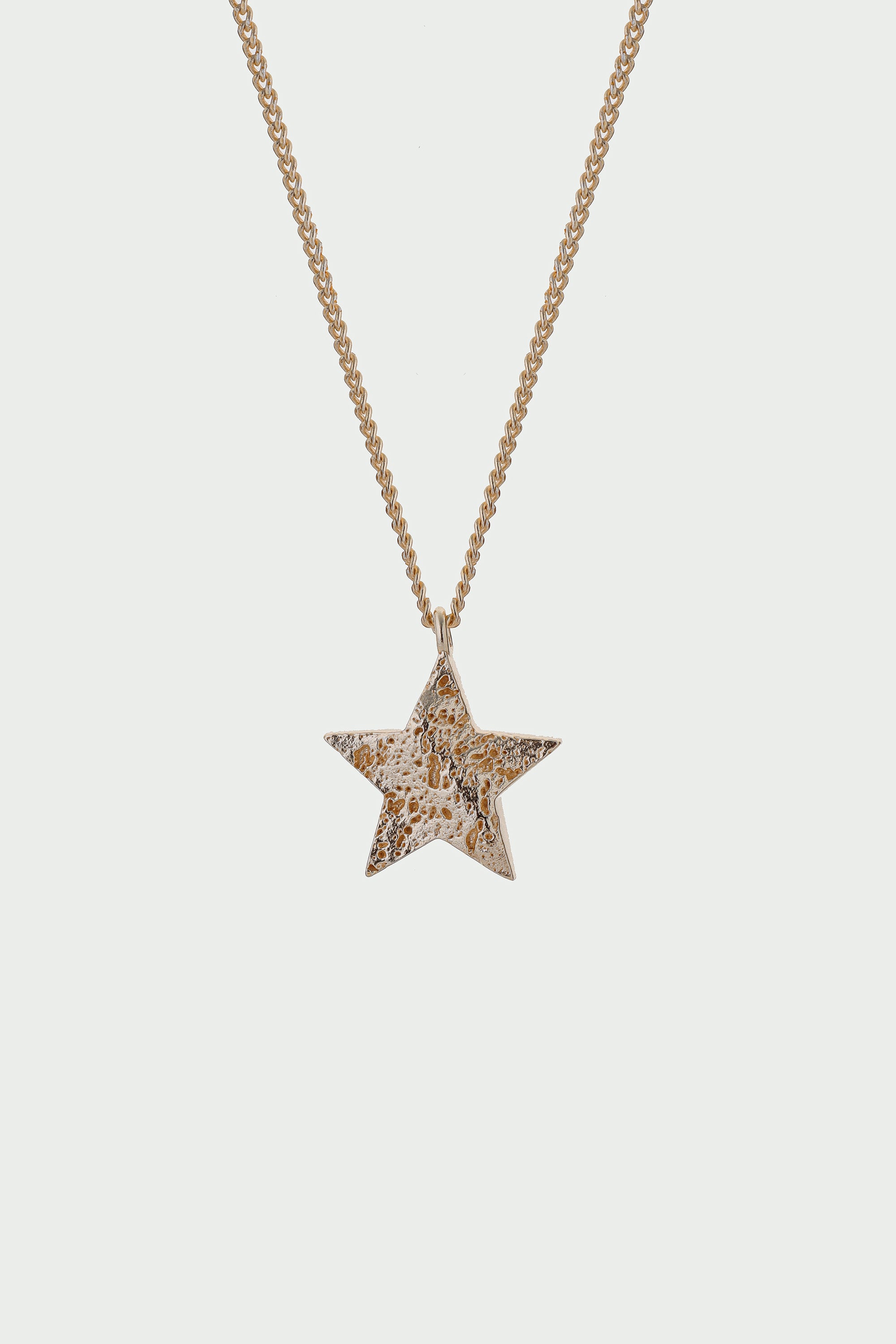Star-shaped pendant necklace on a light gray background